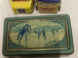 two tins of cigarettes and a box of cigarettes on a table
