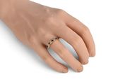 a close up of a person ' s hand with a ring on it