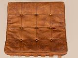 brown leather chair with buttoned seat and back