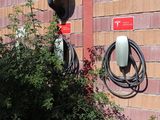 a red brick wall with a bunch of electrical cords attached to it
