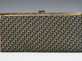 a black and gold clutch bag with a chain design