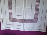 a close up of a table cloth with a square design on it