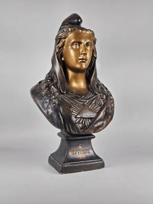 a bronze bust of a woman with a bird on her head