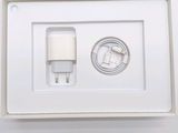 a white box with a charger and a cable in it