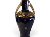 a blue vase with a gold decoration on it