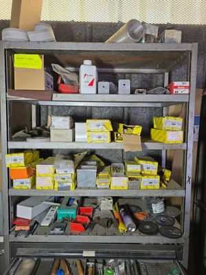 a metal shelving with lots of tools on top of it