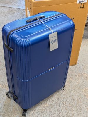 a blue suitcase sitting on the ground next to a cardboard box