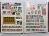 an open book with stamps on it on a table