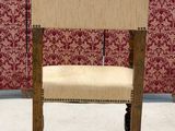 a chair that is sitting in front of a red wall