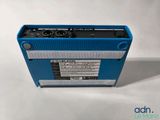 a close up of a blue radio sitting on top of a table