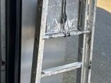 a metal ladder leaning against the side of a building