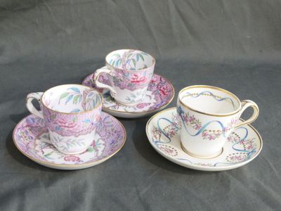 three tea cups and saucers are sitting on a table