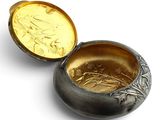a silver and gold box with a gold coin inside of it
