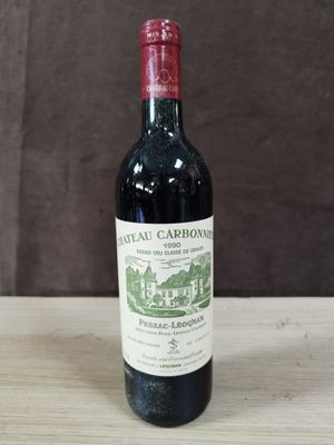 une bouteille de vin rouge posée sur une table en bois