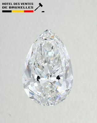 a close up of a pear shaped diamond on a white surface