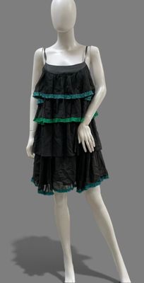 mannequin dressed in black and green dress with green trim