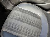 a close up of a car seat with a dirty seat cushion