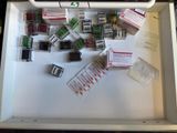 a white box filled with assorted electronic components on a table