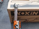 a box of tools on the floor next to a wrench