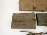 several military items are laid out on a white surface