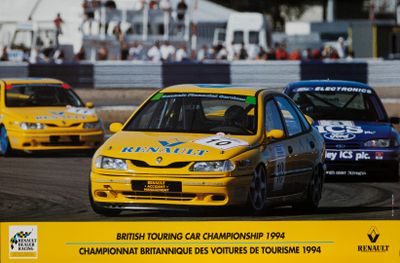 two cars that are racing on a track in front of a crowd