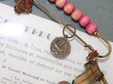 a picture of a brooch with some beads on it