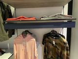 a display of clothes on a shelf in a clothing store