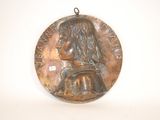 an image of a bronze medal with a woman ' s face on it