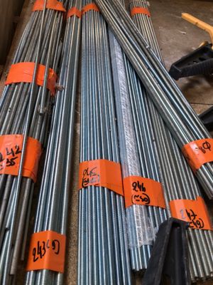 a pile of steel bars stacked on top of each other in a warehouse