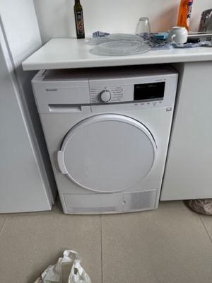 a white washer and dryer in a small kitchen