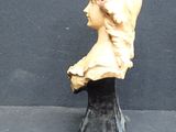 a bust of a woman with a hat on it