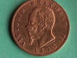 a close up of a coin on a green surface