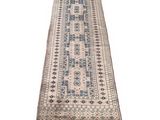 a beige and blue runner rug with fringes on a white background
