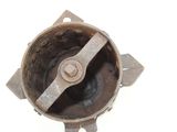 an old rusted metal object on a white surface