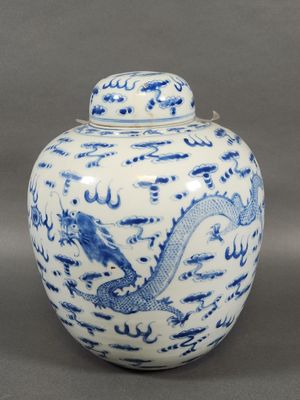 a blue and white vase with a dragon on the lid