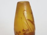 a brown vase with a boat on it sitting on a table