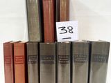 several books are stacked on top of each other on a white surface