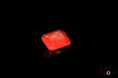 an image of a glowing red diamond in the dark