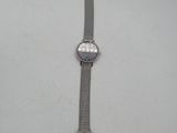 a close up of a watch on a white surface with a price tag