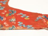 a red dress with blue and yellow flowers on it