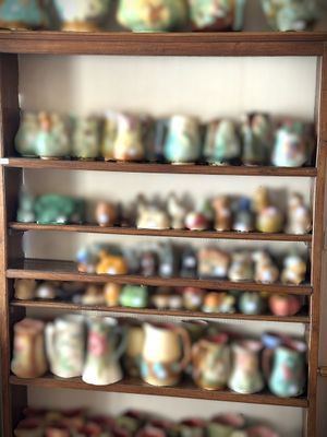 a shelf with many different types of mugs on it