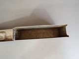 a box that has a piece of wood sticking out of it