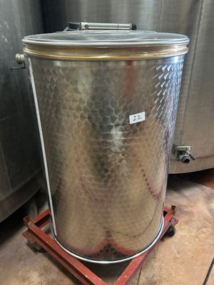 a large metal container sitting on a wooden stand