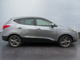 a silver car that is parked in a parking lot