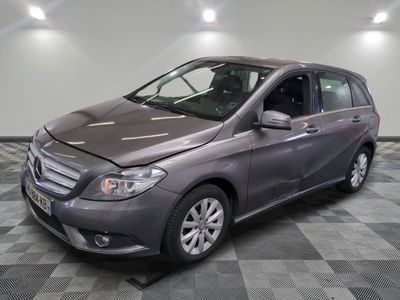 the mercedes b - class is parked on a checkered tile floor