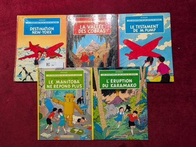 Plusieurs livres pour enfants sont alignés sur une surface rouge