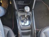 a person sitting in the driver ' s seat of a car
