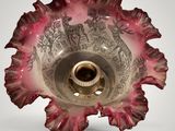 a glass bowl that has a pink flower inside of it