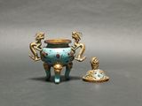 two figurines sitting next to each other on a table