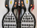 two pairs of black and white shoes with orange soles